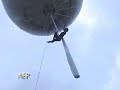 Cirque Aerial Silk Performer Suspended from a Balloon