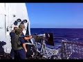 Navy Gunner's Mates training sailors how to shoot the 50cal Machine Gun out to sea onboard the USS Mustin (DDG 89).
