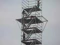 shirtless men make scaffolding tower