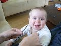 Baby Philip laughs when tickled by his mother