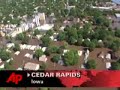 pluscedar rapids remains a city under watercedar rapids remains a city under waterthe associated pressthe view from above says it all, cedar rapids, iowa, is drenched and it may be weeks or months until it dries out completely. (june 14)the water may be on it's way down but the sight of cedar rapids from the air is still breathtaking and overwhelming..it's easy to see why 20,000 people have been evacuated from the area... more than 400 city blocks are still underwater after the cedar river crested friday at 32 feet, 12 feet higher than the previous record..preliminary damages are set at 737 million dollars for cedar rapids alone, and hundreds of other communities have been flooded across the state..in downtown cedar rapids massive high rise buildings are still buried underwater, their basements and first floors destroyed.. the cities infrastructure badly damaged as well, this railroad bridge now lies twisted and broken across the river, another facing incredible stress as the water and dozens of houseboats that broke free from upriver crash into it....neighborhoods along the riverbank that typically don't flood are also covered with only rooftops showing.. some say it looks a lot like hurricane katrina but there is a big difference.  there are no people here.. the water rose slowly over several days, and almost everyone had time to plan an escape... firefighters still rescued some stragglers, but it wasn't the massive effort of katrina.. that's a good thing too, because this is the cedar rapids fire department...while the water is receding experts say it will be a couple of weeks before the water is below flood stage...  and it could be months before the entire area is cleaned up, years before it's all rebuilt.rich matthews the associated press over cedar rapids iowa...