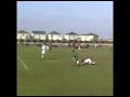 this kid dribbles the ball and blasts through the opposing defense and scores twice versus local opponent.