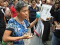 Woman led away by police at PAP lunch time rally