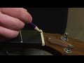 How to Change the Strings on an Acoustic Guitar : How to Lubricate the Nut with Graphite on an Acoustic Guitar