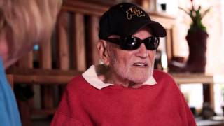 older Veteran man with cap and sunglasses