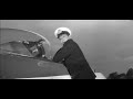 naval officer david tomlinson argues with a sea scout about how an early jet fighter works and in doing so starts the engine and the backwash whips the uniforms off a nearby parade of wrens
