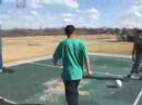Guy kicks soccer ball in the basket...