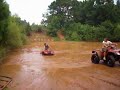 dj playin in the water on his honda rancher 420
