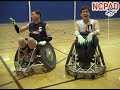 Photo of two wheelchair rugby players.