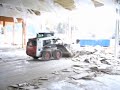 Bobcat 763 pushing a plaster pile
