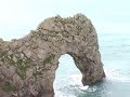 A climb, then a jump, off the famous naturally formed arch 'Durdle Door' in Dorset, England.