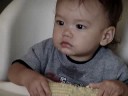 Alexaner has his first cob of corn. Alexaner has his first cob of corn.