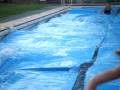caitlin and emily running over pool covers