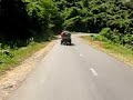 Me cycling down a hill in the east of Sumbawa, Indonesia, and being passed by a rather strange vehicle. My brother says it's a kind of multi-task engine thing - car, pump, generator, what have you. 