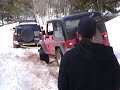 Fj cruiser getting pulled out by a jeep wrangler
