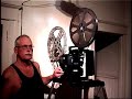 Man Operating 16mm Projector Man Operating 16mm Projector