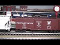 Just about nine years ago, I got the MTH Premier model of the Pennsylvania Railroad Q2, a duplex-drive 4-4-6-4 freight hauling behemoth of a steam locomotive. It was one of the first locomotives equipped with Protosound 2 (PS2). I've had it running on and off all the years since and it still runs great. In this True HD 1080p video, you can see it hauling my PRR freight train. Since the feedback I've received about this train has been quite positive, I visited the train store recently and bought quite a few more cars to add to it. In the slow speed run-by you can get a good look at the now two dozen car train. Following the higher speed run-by, you can watch as the Q2 uncouples from the train and returns to its track in my locomotive ready yard. Please visit my web site -- www.toytrains1.com -- for lots more videos and photos of both real and model trains.