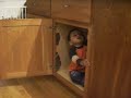 Ander hides in the kitchen (15 months old)