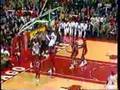 Michael Jordan jumps over a guy's shoulder