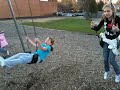 Two girls swinging