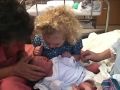 Little Girl Comforts Newborn Baby Sister