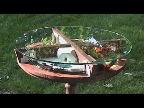 z scale model train layout - A model railway that is a train moving through sections of a zoo representing summer, fall, winter and spring. The layout is built into a glass-top side tabl...