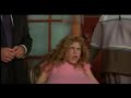 a dirty shame - be - caprice (selma blair), is under house arrest following a series of convictions for exhibitionism, and she had previously been a topless go-go dancer at a local biker bar, the holiday house. her stage name was ursula udders, due to her ridiculously enormous breasts, the result of cosmetic surgery.