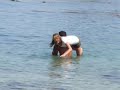 Guy Dips Clothed Girl in Ocean