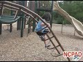 Picture of a child with autism climbing stairs on equipment.