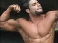 Ripped bodybuilder Mike Patino posing outdoors