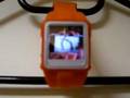 Orange MP4 Video Wristwatch playing iPhone ad