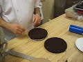 chocolate cake being covered with butter cream