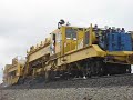 These two units were working their way east on the BNSF mainline just east of Spokane WA on 4/8/2008.  One doesn't want to get too close - the Surfacer throws rocks at you!  After they pass we see 3 signalmen re-attaching bond wires.