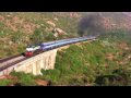 A loud and smoky ALCo KJM WDM-2 16669 with Hindupur-Yeshwanthpur passenger takes the loop to stop at Makalidurga station. But because of the gradient, has to notch up to keep the speed up.