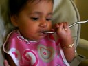 Sahira feeding herself with a spoon!
