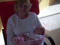 Proud Grandma holding sleeping baby