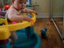Smiley Ryan playing in his exersaucer 8 months old