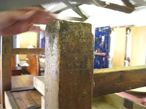 woodworm - A http://gilboys.co.uk antique furniture restorer seen here in the workshops based just outside of Totnes Devon, hand sawing through a badly wood-wormed anti...