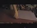 a demonstration on how to make tissue foil for origami. foil, spray adhesive, tissue paper, cutting board, razor, tube and newspaper.