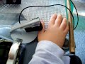 Casey using his microlite switch with his DynaVox