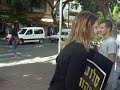 Distributors of leaflets saying Uzi Salant is a corrupt hide their faces, ask not to film around