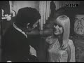 Serge Gainsbourg and France Gall walk around in the decor of a French TV show, singing 'Les Sucettes'.