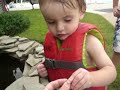 Noah throwing money in fish pond Noah throwing money in fish pond