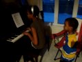 Keza Ruzima and little brother Joshua Shema having  fun on the Piano