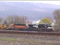 a dash-9 and a furx sd40-2 lead 62a into marysville, pa, near harrisburg. in addition to the john deere cotton pickers on this train, are three cat front-end loaders.