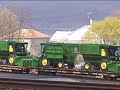 a dash-9 and a furx sd40-2 lead 62a into marysville, pa, near harrisburg. in addition to the john deere cotton pickers on this train, are three cat front-end loaders.