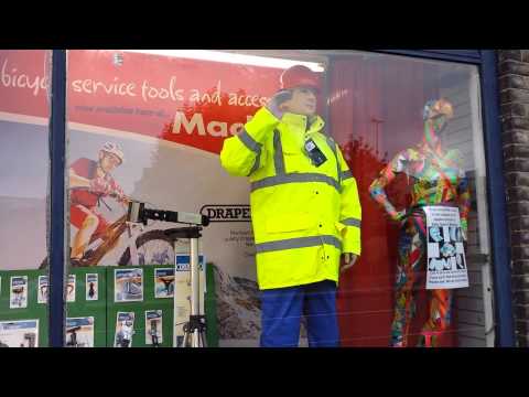Mackays mannequin Dickie Mackay, waving in the shop window mannequin-man performming as a Living Mannequin: Reprising the role of the Dickie Mackay mannequin for an open day at Mackays of Cambridge. for Mackays on 15/10/2014