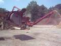 Grinding logs in a Morbark 1300 tub grinder chipper