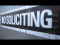 No Soliciting Sign in Store Window of Local Business on Main Street of City | HD Stock Video Footage