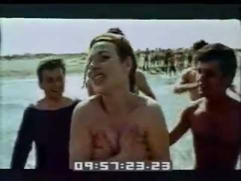 شاطى العرى - On a beach in Italy, a buxom young woman does a long but tame striptease down to her two piece bathing suit. Footage shows her striking sexual poses. More sh...